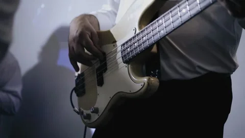 The bass player plays on stage with his band. Close-up shooting Stock Footage 314215498