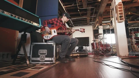 Bass Player Sitting Low Angle Move In and out Stock Footage 89540075