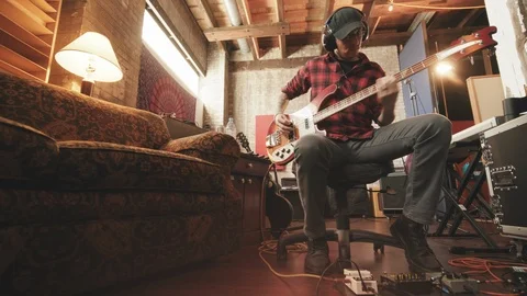 Bass Player Sitting in Recording Studio with Couch Move In Stock Footage 89511469