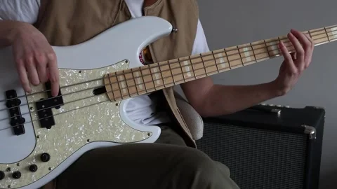 A bass player using the fretting technique Stock Footage 333391112