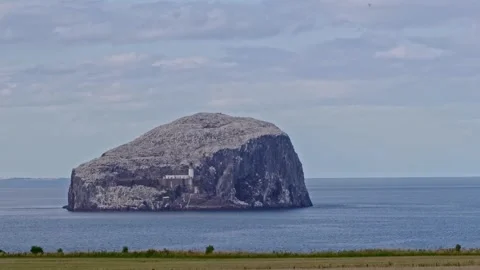 Bass Rock with foreground fields Stock Footage 246633733