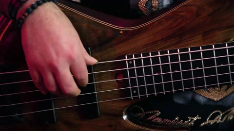Bassguitar player playing slowly e-bass | 4K Stock Footage 157812922