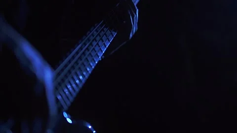 Bassist player performing in blue light and slow motion Stock Footage 318551880