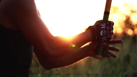 The bassist is practicing baseball bat catching with the sunset 스톡 동영상 133120506