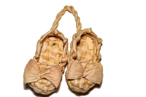 Bast shoe on a white background. Two wicker bast shoes tied together. Stock Photos