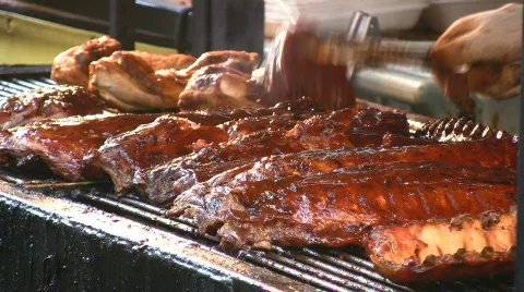 Basting BBQ Sauce On Chicken And Pork Ribs On A BBQ Grill Outdoors Ribfest Stock Footage