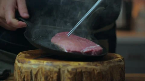 Basting raw beef steak with olive oil Video stock 259943208