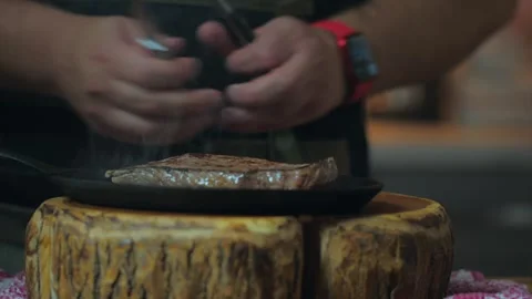 Basting raw beef steak with olive oil Video stock 259943269