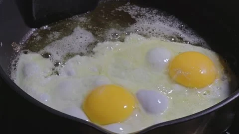 Basting Sunny Side Up Eggs with Hot Oil for Perfect Yolks Stock Footage 321499743