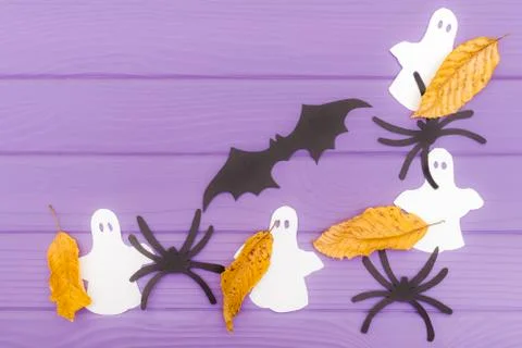 The bat, ghosts and spiders different paper silhouettes with autumn leaves made Stock Photos
