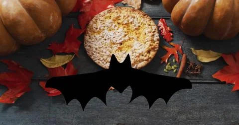Bat image over autumn leaves, pumpkins, and pie on wooden background Stock Illustration