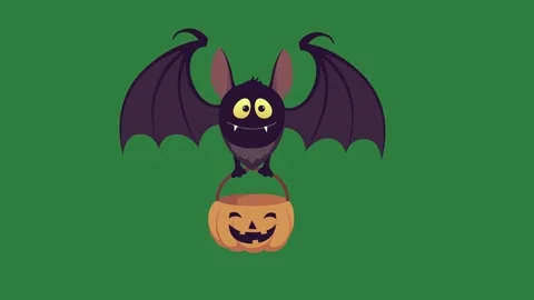 A bat sitting on top of pumpkin and with in its mouth green screen motion Stock Footage 337339945