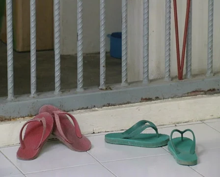 Batam Indonesia prison two pair of sandals at a cell  Stock Footage 643957