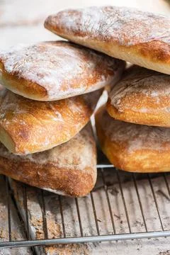 Batch of ciabatta bread on a cooling rack. Stock Photos