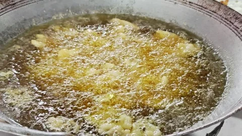 Batch of food deep frying in boiling golden cooking oil. Stock Footage 342696619