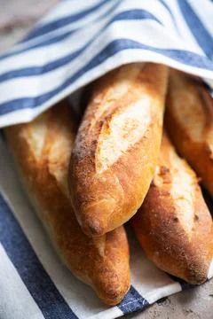 Batch of freshly baked baguettes background. Stock Photos