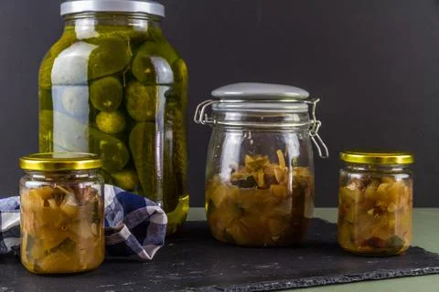 Batch of home made marrow chutney jars and pickled gherkins, landscape. Stock Photos