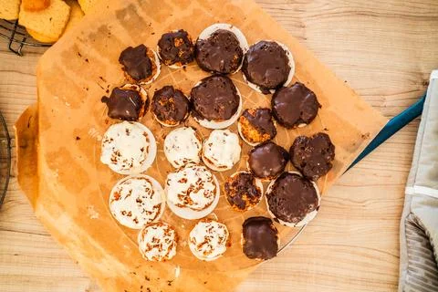 Batch of Macroons Covered with White and Dark Choclate on Baking Paper in a.. Stock Photos