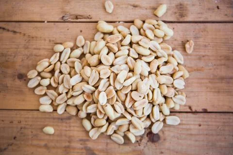 Batch of peanuts on the wooden background Stock Photos