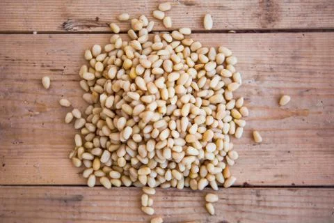 Batch of shelled pine nuts on the wooden background Stock Photos