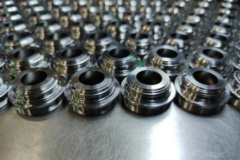 A batch of shiny metal cnc aerospace parts production - close-up with selecti Foto stock