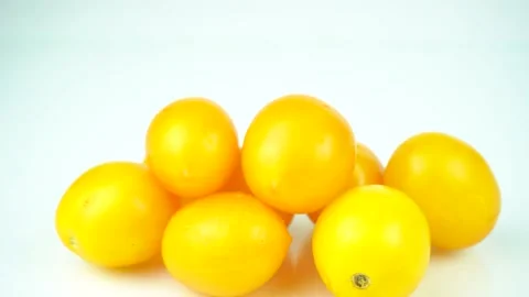 Batch of yellow fresh tomatoes isolated on white background Stock Footage 139114473