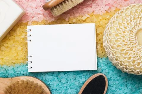 Bath accessories and blank notepad over colored sea salt Stock Photos