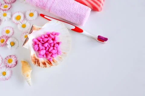 Bath accessories lie on a white background with spring flowers Stock Photos