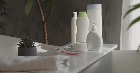 Bath accessories in plastic bottles on bathtub table in spa. Stock Footage 260501365