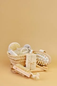 Bath accessories set in wicker basket on a beige background. Stock Photos