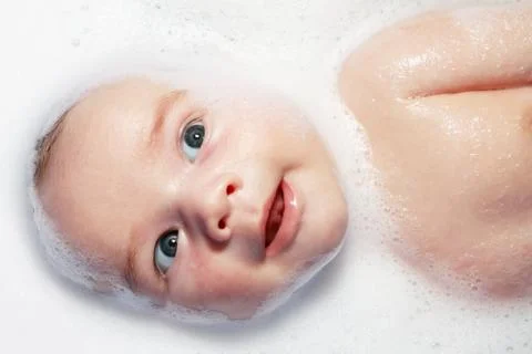 Bath and newborn with foam Stock Photos