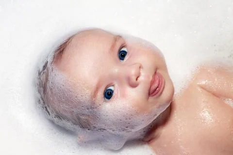 Bath and newborn with foam Stock Photos
