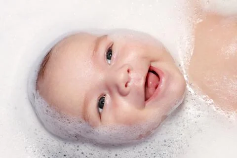 Bath and newborn with foam Stock Photos