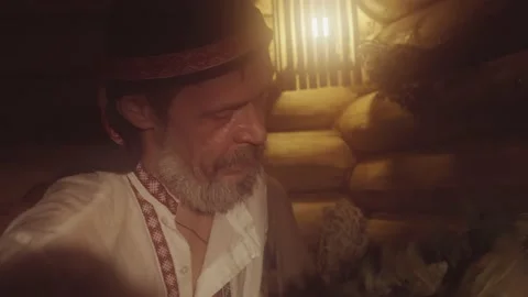 A Bath Attendant Making Spa Massage With Oak Brooms To A Boy In Russian Sauna Stock Footage 146599320