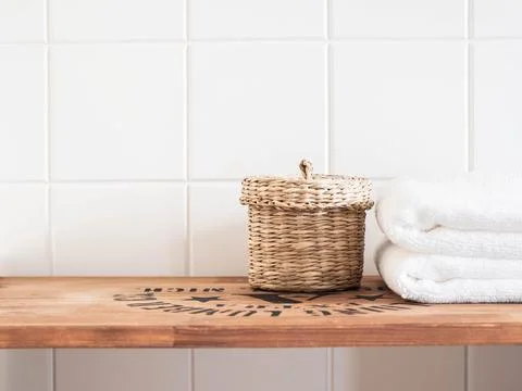 Bath background front view with straw box and white towels on brown wood shel Stock Photos