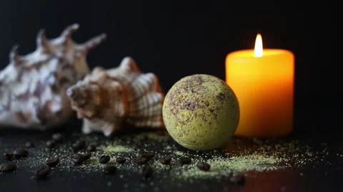 Bath bomb and coffee beans, with seashells and burning candles Stock Footage 158807716