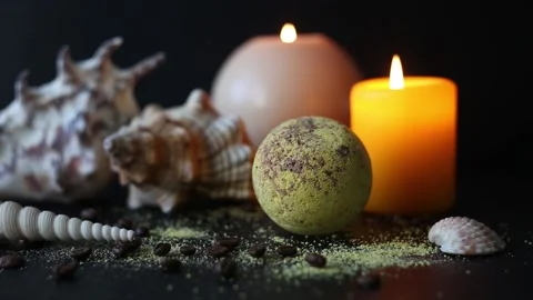 Bath bomb and coffee beans, with seashells and burning candles Stock Footage 158807752