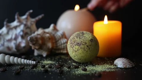 Bath bomb and coffee beans, with seashells and burning candles. Spa concept. Stock Footage 158807764