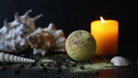 Bath bomb and coffee beans, with seashells and burning candles Stock Footage 158807777