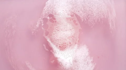 Bath bomb ball dissolves in water with white foam bubbles. Cosmetic product Stock Footage 276542736