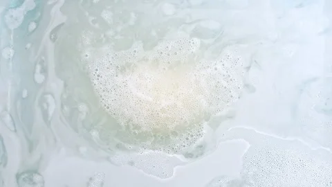 Bath bomb ball in the shape of a heart dissolves in water with white foam 動画素材 267981269