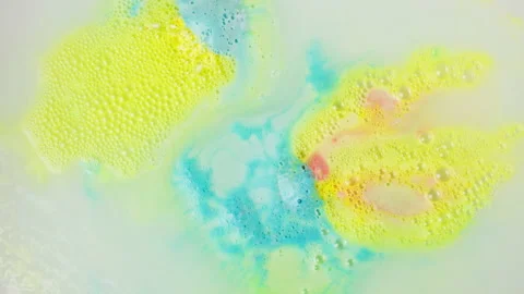 Bath bomb in water close-up. Soap ball dissolving, foam bubbles. Decorative Stock Footage 166314332