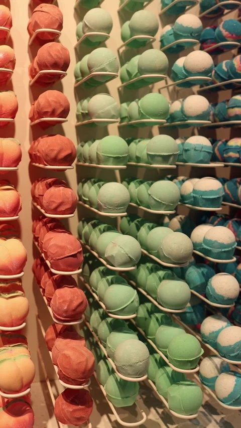 Bath bombs arranged by color on wall Video stock 332163733
