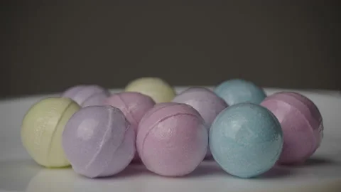 Bath Bombs in Different Colors Spin Against a Black Background. Stock Footage 170321220