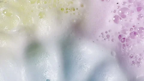 Bath bombs produce fizz and bubbles in undulating graphic element Stock Footage 334053172