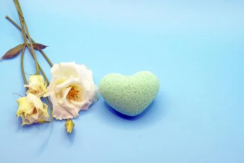 Bath bombs in the shape of a heart close-up on a blue background with an eust Stock Photos