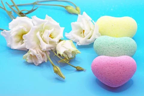Bath bombs in the shape of a heart close-up on a blue background with an eust Stock Photos