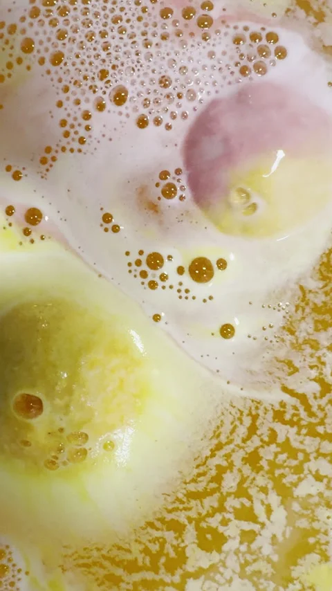 Bath bombs spin and fizz creating colorful background plate Stock Footage 334762958