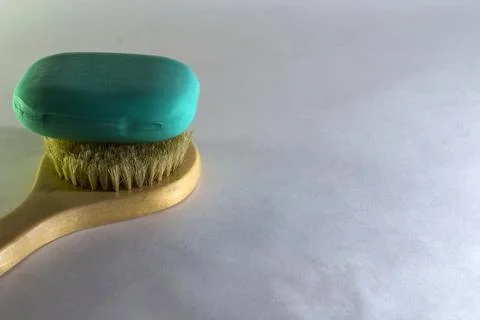 Bath brush with soap on a white background. Stock Photos