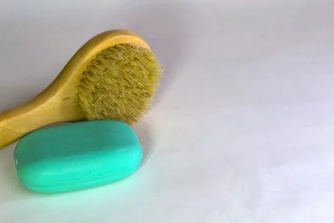 Bath brush with soap on a white background. Stock Photos